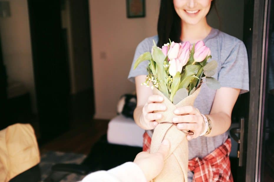 Woman receiving flowers as a mother's day gift